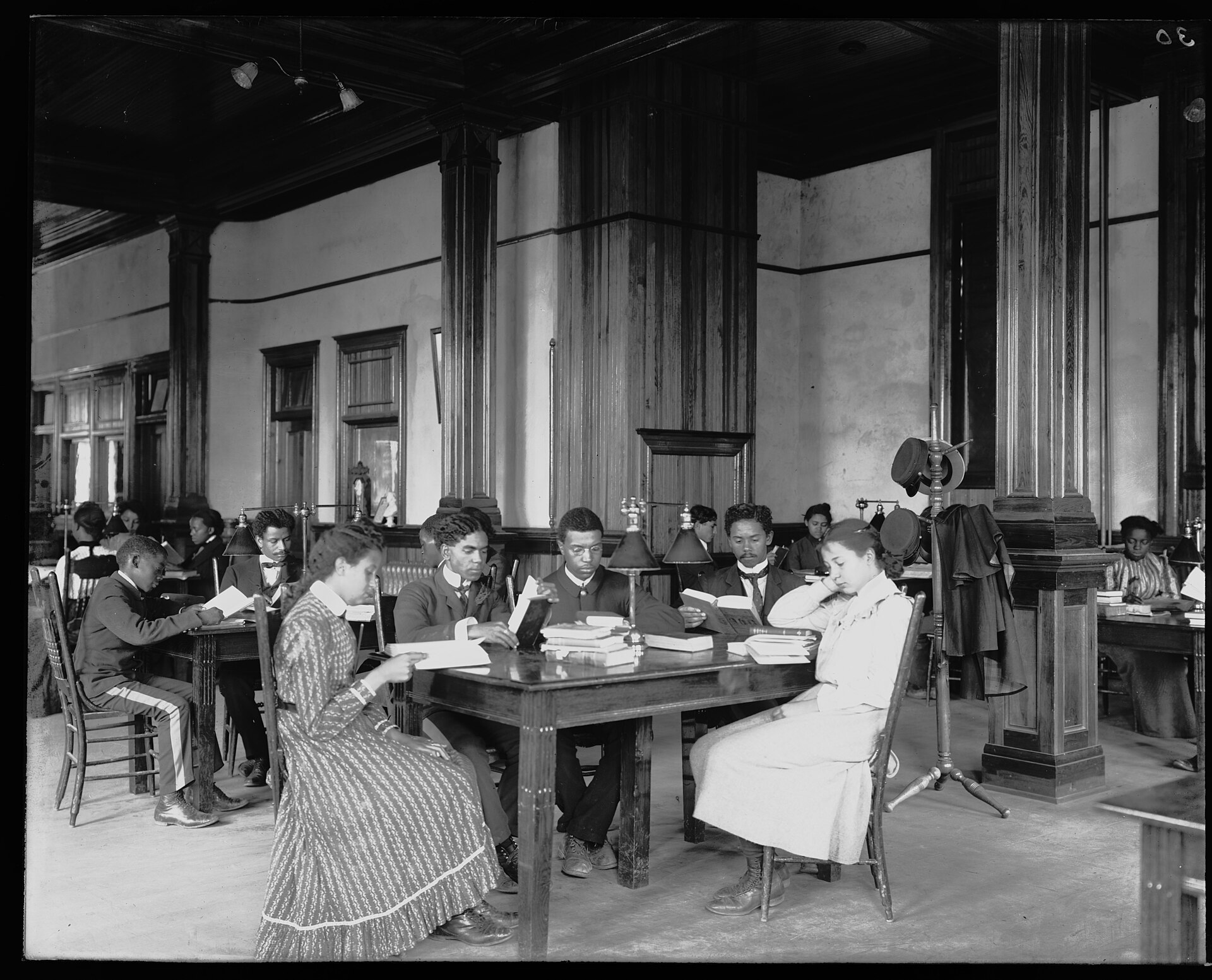 Interior view of library reading room with male and female students sitting at tables, reading, at the Tuskegee Institute LCCN2009632000.jpg